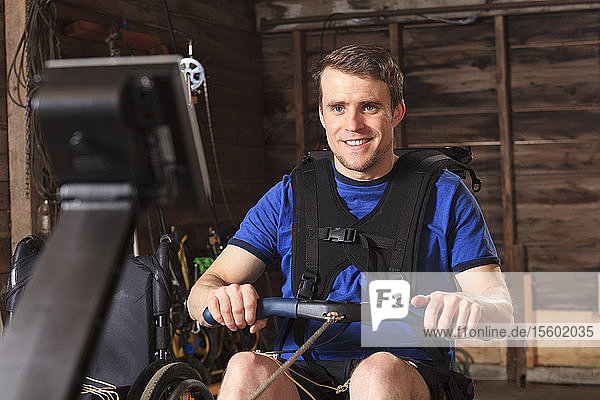 Man with spinal cord injury using his rowing machine