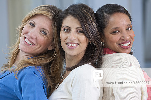 Portrait of three women smiling
