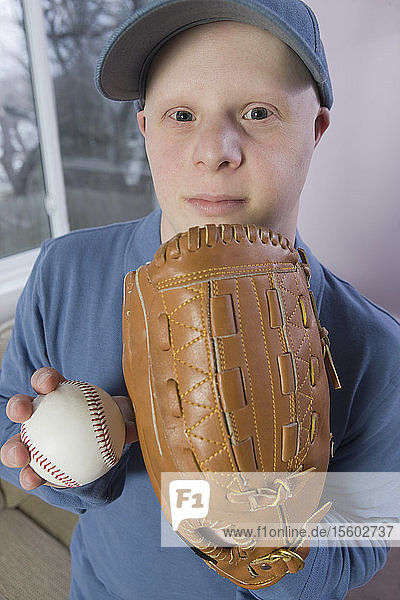 Mann mit Down-Syndrom mit einem Baseballhandschuh und einem Baseball