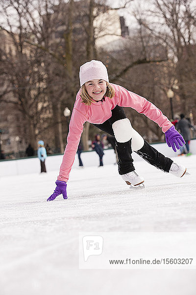 Girl ice skating on a rink