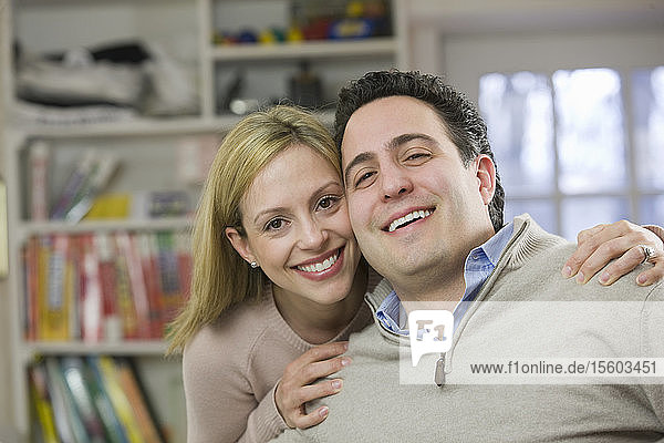 Portrait of a woman smiling with a Hispanic man
