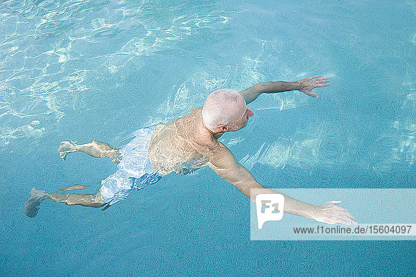 High angle view of a senior man in a swimming pool  Florida  USA
