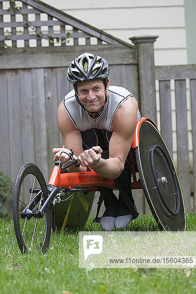 Man with spinal cord injury in disability racing bike
