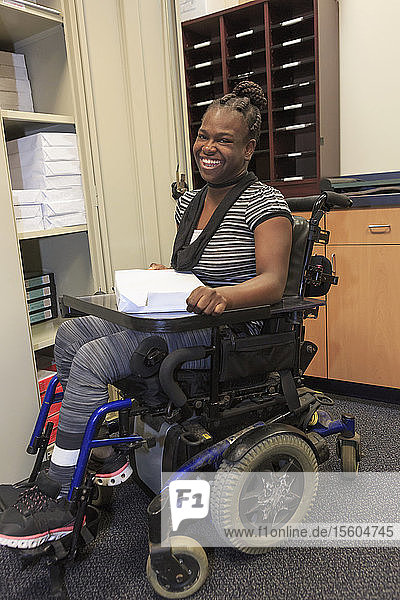 Teen with Cerebral Palsy getting copy paper
