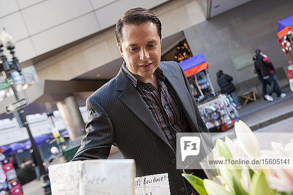 Businessman shopping flowers in a market