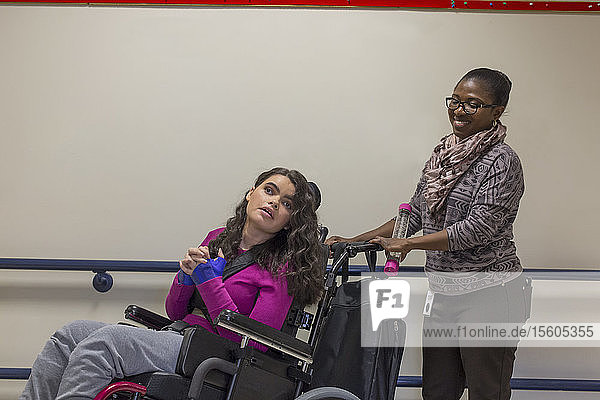 Girl with Tuberous Sclerosis learning at school with caretaker