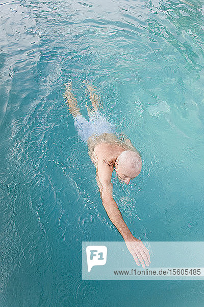 High angle view of a senior man in a swimming pool  Florida  USA