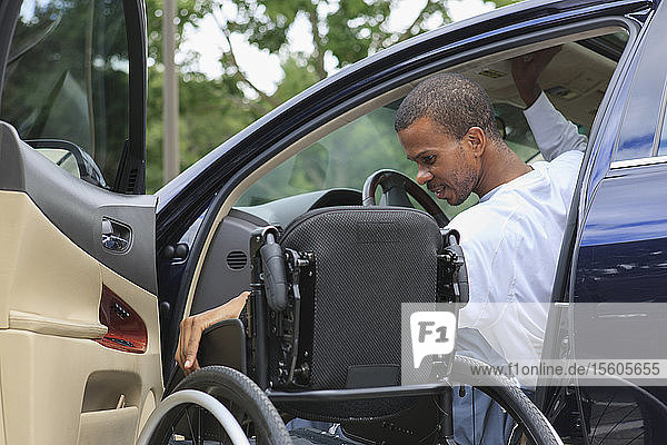 Mann mit Hirnhautentzündung betritt mit seinem Rollstuhl sein Auto