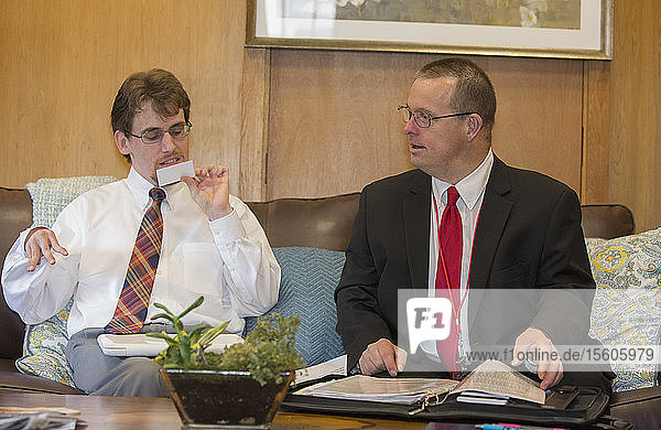 Man with Down Syndrome working with a collaborator in the State Capitol office