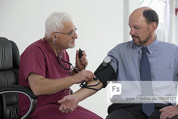 Doctor measuring patient's blood pressure