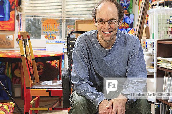 Portrait of an artist with Asperger's in his studio