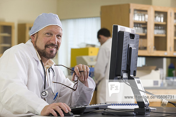 Lab technician working a computer