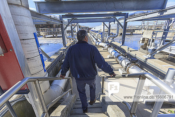 Engineer walking through water treatment plant