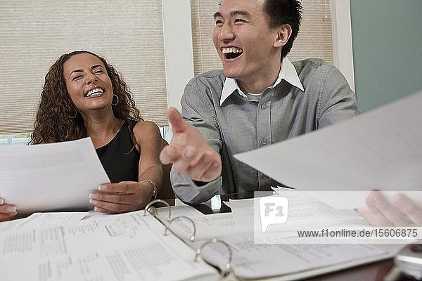 Visually impaired Hispanic businesswoman with a businessman in an office