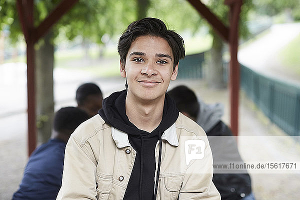 Portrait of smiling young man at park