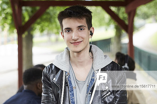 Portrait of confident teenage boy at park