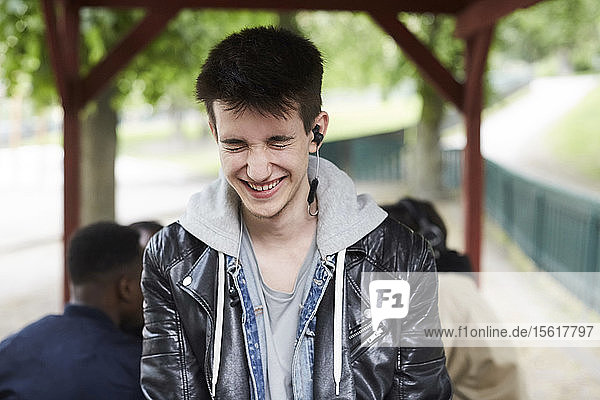 Smiling teenage boy with eyes closed