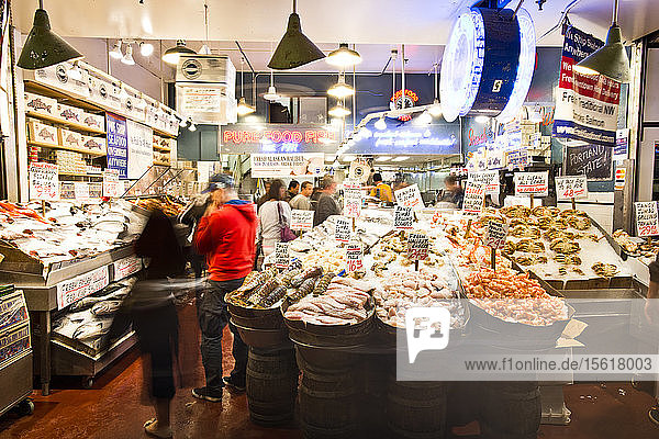 People look at the seafood on display at Pike Place Market in Seattle  Washington.