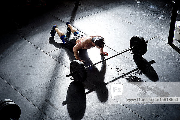 A crossfit athlete doing burpees at a gym in San Diego  CA.