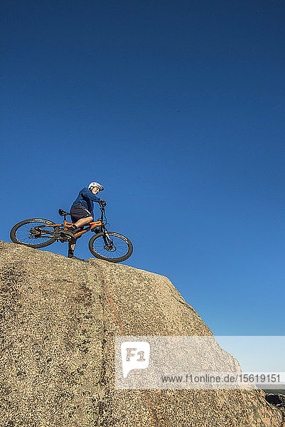 Low Angle View Of Alex Leich With Mountain Bike On The Bare Granite Slabs In North Conway New Hampshire