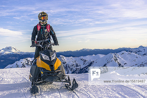 Front view of single adventurous man on snowmobile in mountains in winter  Whistler  British Columbia  Canada