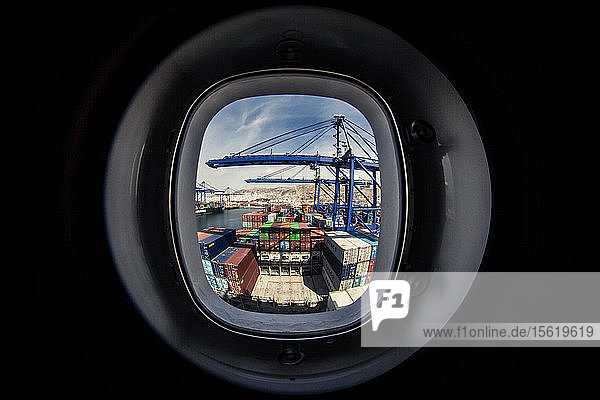 Watching a container ship being loaded from a window on one of the living quarters decks.