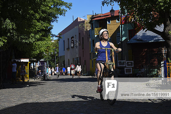 Ein Mädchen Reiten Bamboo Fahrrad in La Boca Nachbarschaft in Buenos Aires  Argentinien