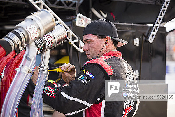 Pit crew member making repairs  New Hampshire Motor Speedway  NASCAR 301 Sprint Cup