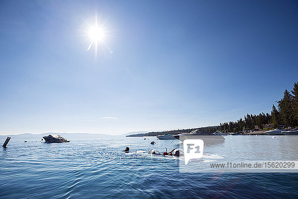 Photograph with prototype two-man personal submarine partially submerged in Lake Tahoe  California  USA