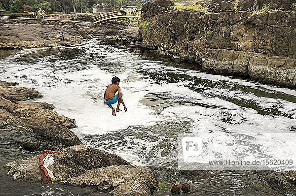 A boy jumping in to the river  Materavadi  Maharashtra  India.