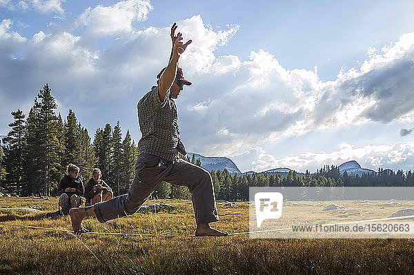 Side view of adventurous man balancing whileï¿½slacklining  ï¿½Tuolumneï¿½Meadows  Yosemite National Park  California  USA