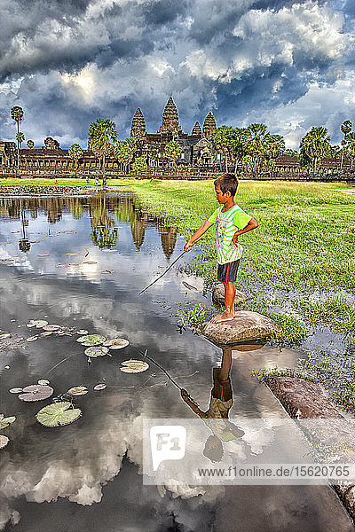 Angkor Wat was first a Hindu  then subsequently a Buddhist  temple complex in Cambodia and the largest religious monument in the world. The temple was built by the Khmer King Suryavarman II in the early 12th century in Yasodharapura  the capital of the Khmer Empire  as his state temple and eventual mausoleum. Breaking from the Shaivism tradition of previous kings  Angkor Wat was instead dedicated to Vishnu. As the best-preserved temple at the site  it is the only one to have remained a significant religious center since its foundation. The temple is at the top of the high classical style of Khmer architecture which got major influence from Kalinga architectural style. It has become a symbol of Cambodia  appearing on its national flag  and it is the country's prime attraction for visitors.