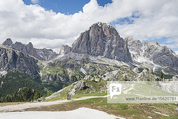 Long Exposure Of Couple Hiking At Cinque Torri Area In Dolomites  Italy