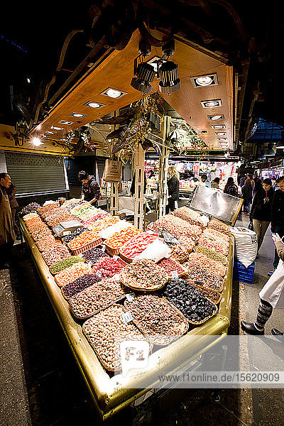 Piles of assorted nuts at a farmers market in Barcelona, Spain.