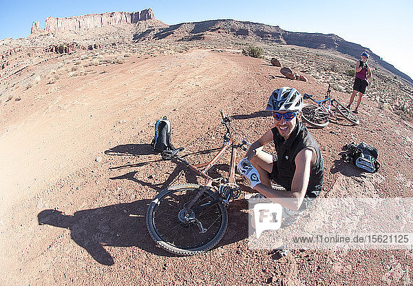 Friends explore the Utah desert in autumn with an extended mountain biking adventure on the White Rim Trail  Canyonlands National Park near Moab  Utah.