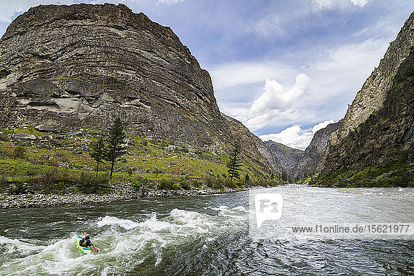 Kayaker paddling down the Impassable Canyon on the Middle Fork of the Salmon  Idaho.
