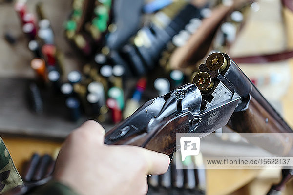 Close up of man hands loading shotgun with two shells  Tikhvin  Saint Petersburg  Russia