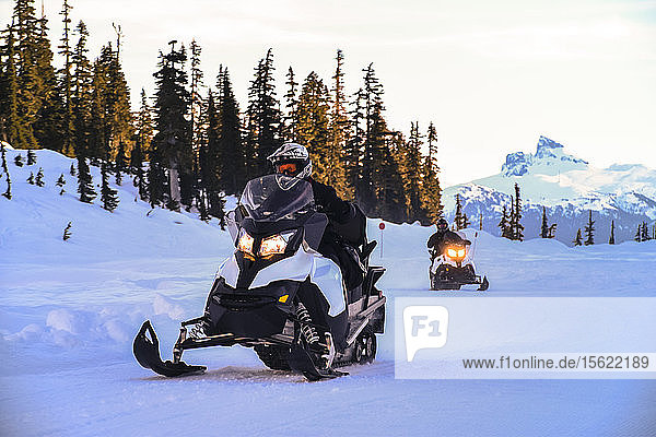 Front view of adventurous man riding snowmobile  Callaghan Valley  Whistler  British Columbia  Canada