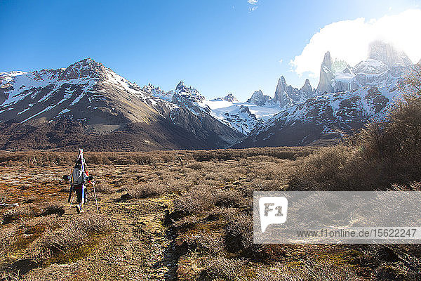 Brody Leven hikes through a barren field to reach the mountains in the distance. El Chalten  Patagonia  Argentina