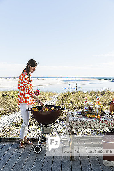 A woman grilling on the beach in Florida
