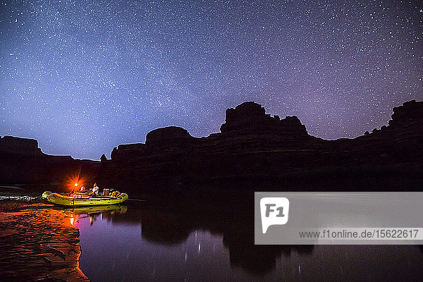 Rafts and camp along the Colorado river at night. Photo taken during a rafting trip down Cataract Canyon Utah.