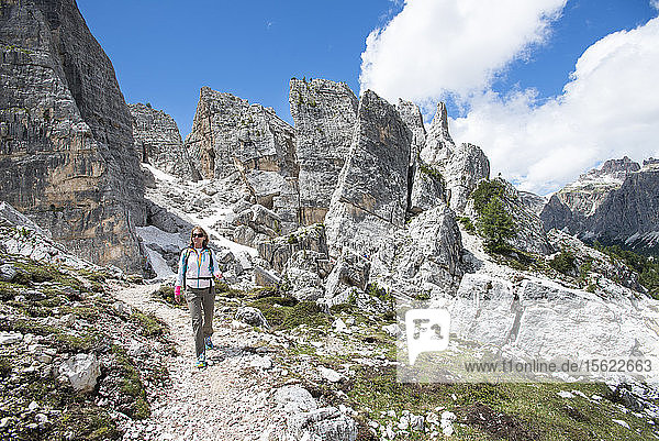 A Woman Hiking At The Cinque Torri Area In The Dolomites  Italy
