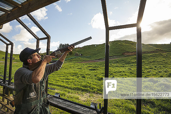 Man aiming shotgun  Tauranga  Bay of Plenty  New Zealand