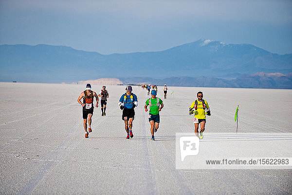Competitors run across the Bonneville Salt Flats during the Salt Flats 100 in Bonneville  Utah.