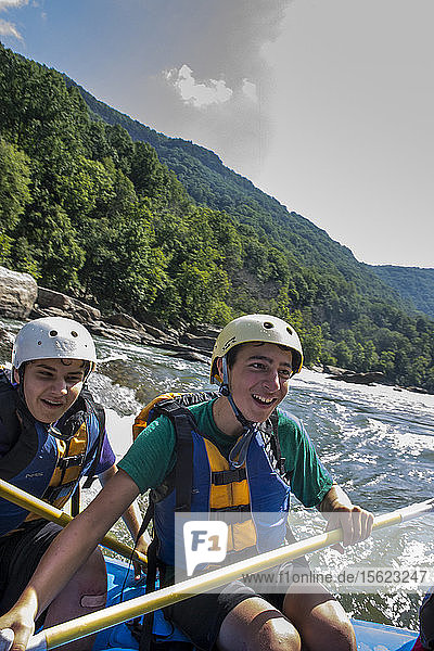 Order of the Arrow scout Noah Lopez (front) and Patrick Bonorden have a blast while riding a raft through a rapids on the New River  during a whitewater adventure in the New River Gorge  near Fayetteville  outside of the Summit Bechtel Reserve (SBR)  WV. The OA scouts are participating in a service and adventure program at SBR.