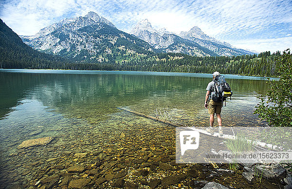 A Backpacker Looking At The Grand Teton Mountains  Jackson Hole  Wyoming