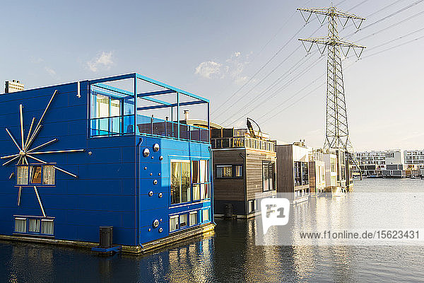 The Netherlands are notoriously flat and low lying  with 50% of the country lying below sea level. Climate change is leading to both sea level rise and increased flooding  both of which threaten poperties. One solution is to build floating houses  that rise and fall with altering water levels. Ijburg  a suberb of Amsterdam is the floating house capital  with increasing numbers of flaoting houses being constructed.