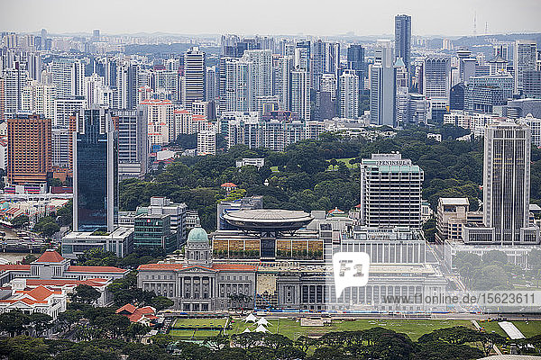 A daytime ariel view of the Supreme Court building and the neighboring skyline in Singapore as seen from the roof of the Marina Bay Sands Hotel.