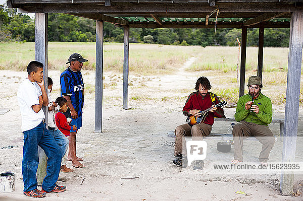 Village People Looking At Two Man Playing Music  Bolivar State  Venezuela