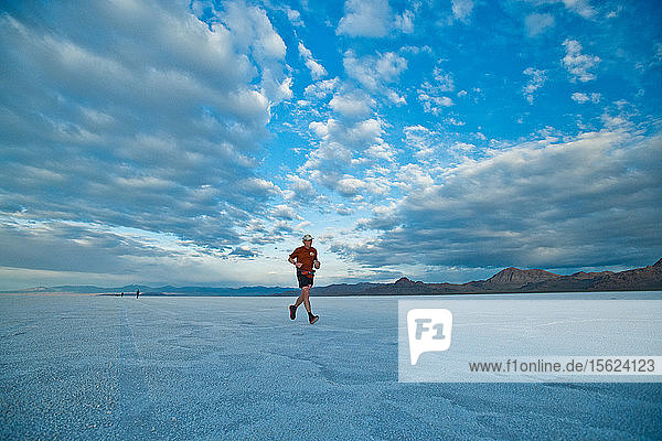 A male athlete runs across the Bonneville Salt Flats during the Salt Flats 100 in Bonneville  Utah.